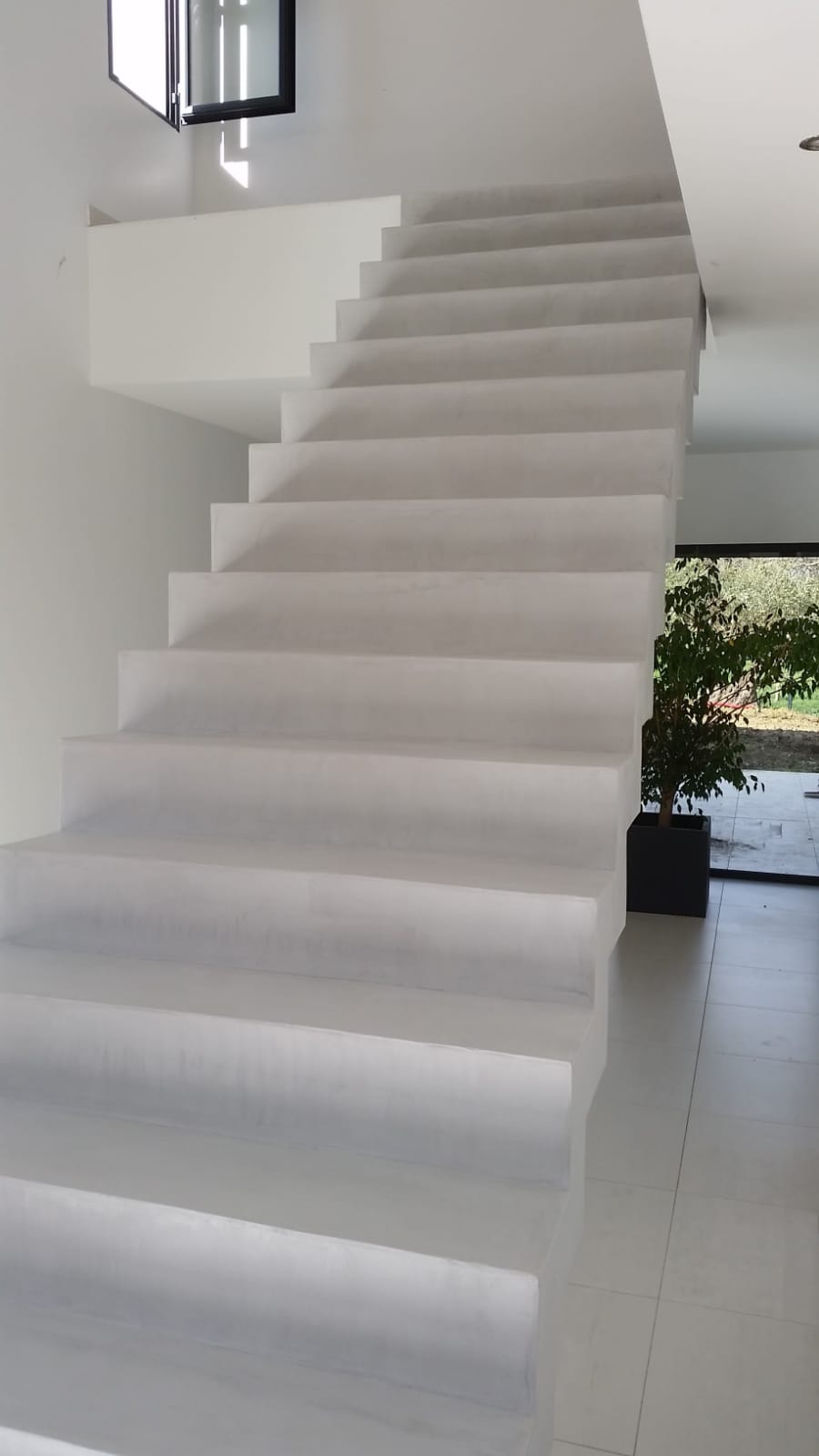 elégant escalier crémaillère avec effet flottant habillé en béton ciré couleur gris cendré à toulouse pour un particulier