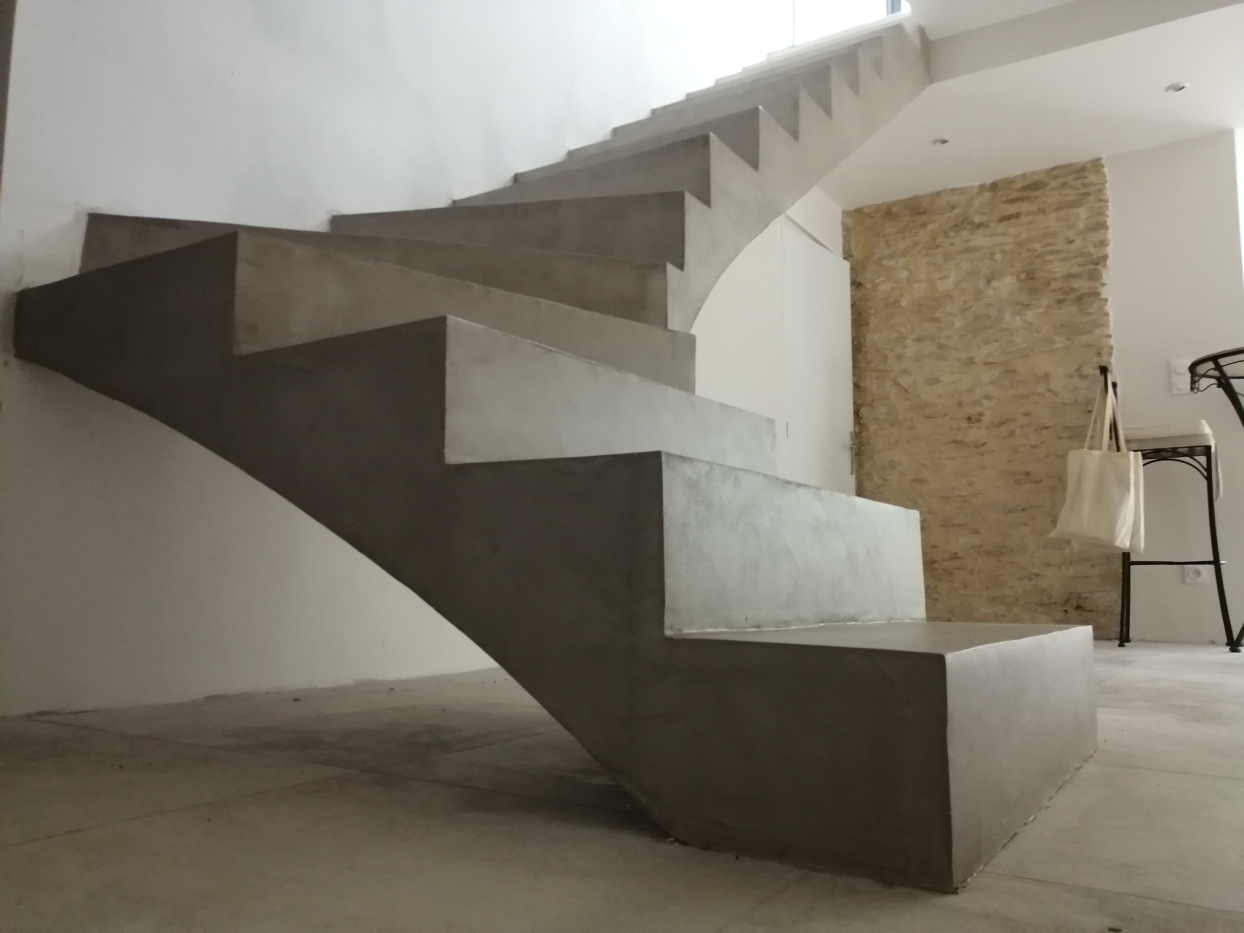 elégant escalier à paillasse un quart balancé en béton ciré vernis mat couleur galet original à Nîmes dans le département du Gard (30000) en Languedoc pour un particulier