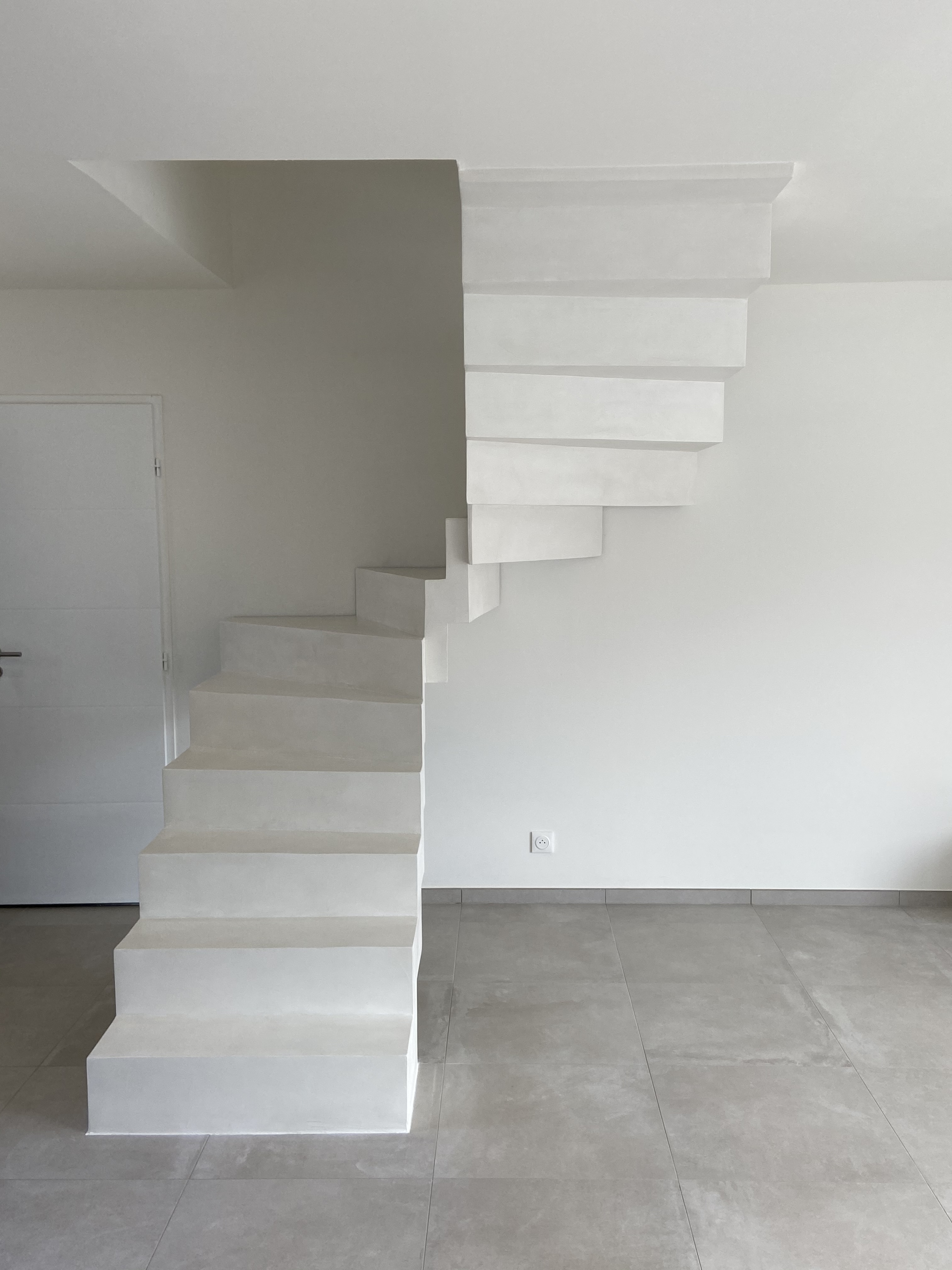 Escalier en béton ciré, finition vernis mat velouté, en région Occitanie. Matière saine et facile d'entretien.